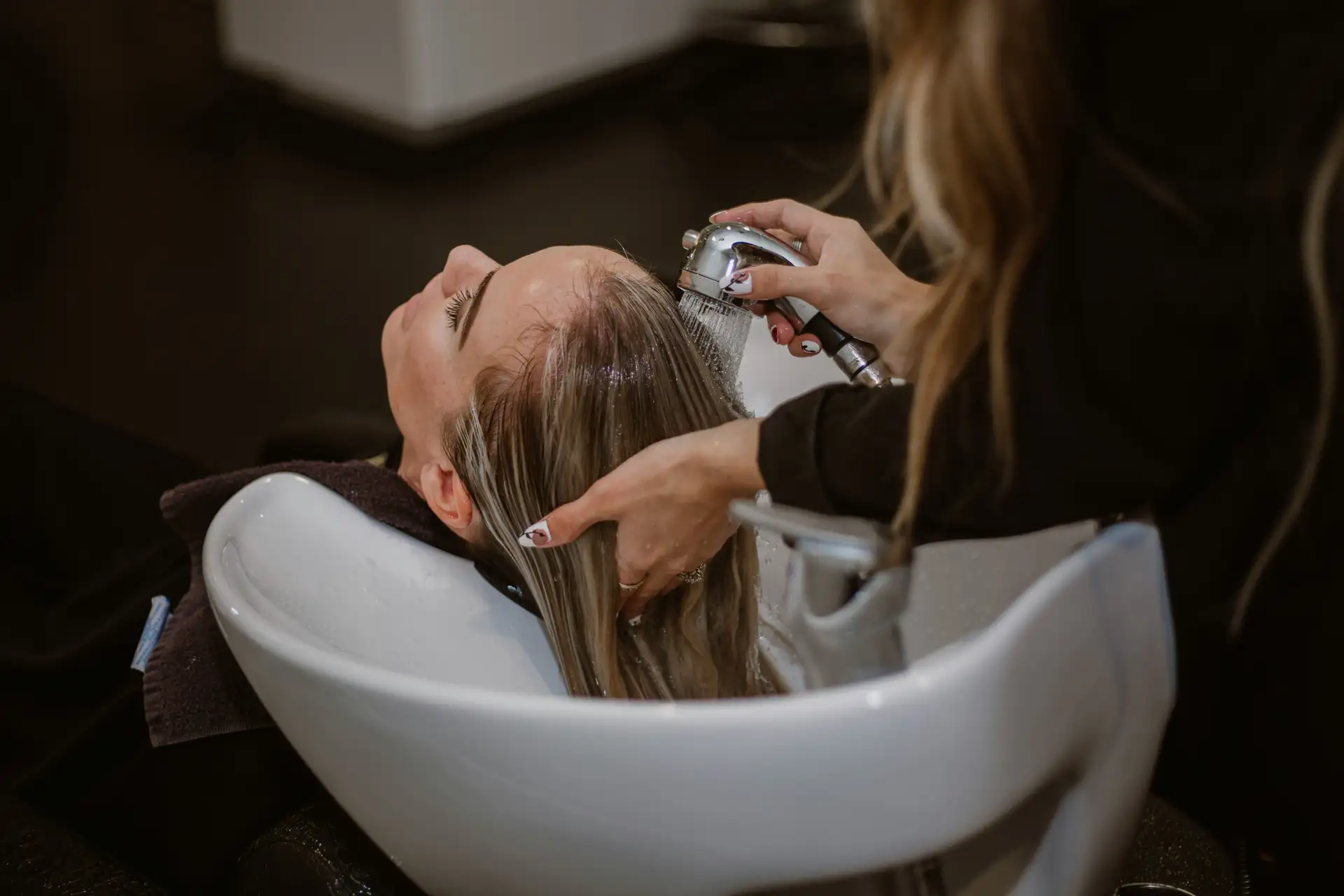 Stylist blowdrying and shaping a gorgeous precision trim